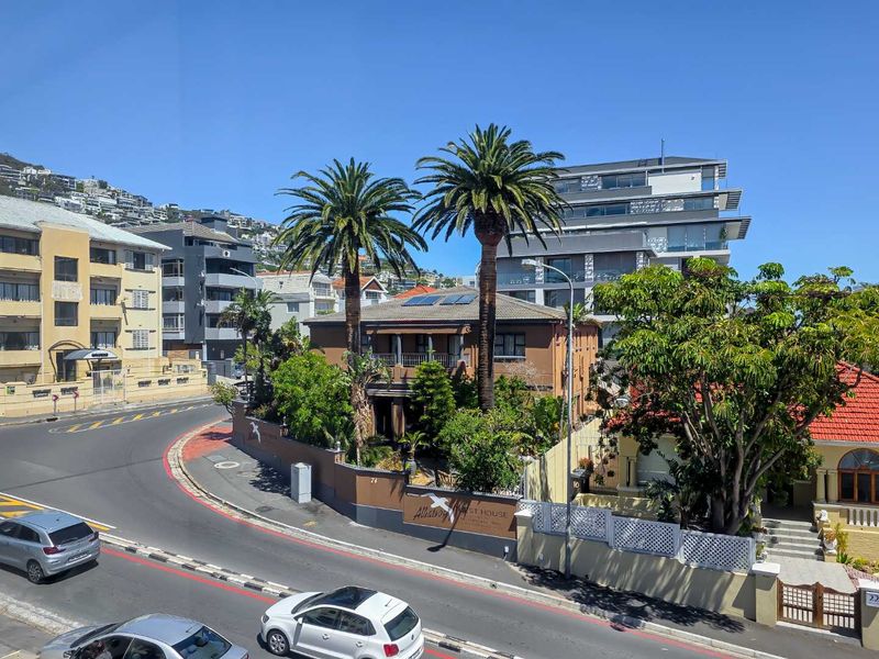 Elevated street view of the property facade, showcasing the building exterior, surrounding landscaping, and neighborhood context.