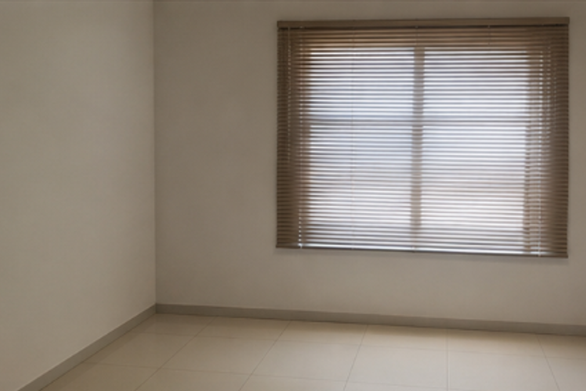 A clean, empty office space featuring neutral tiled flooring and fitted venetian blinds, providing a bright and versatile workspace.