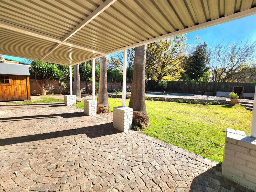 View from patio, across garden to pool and shed