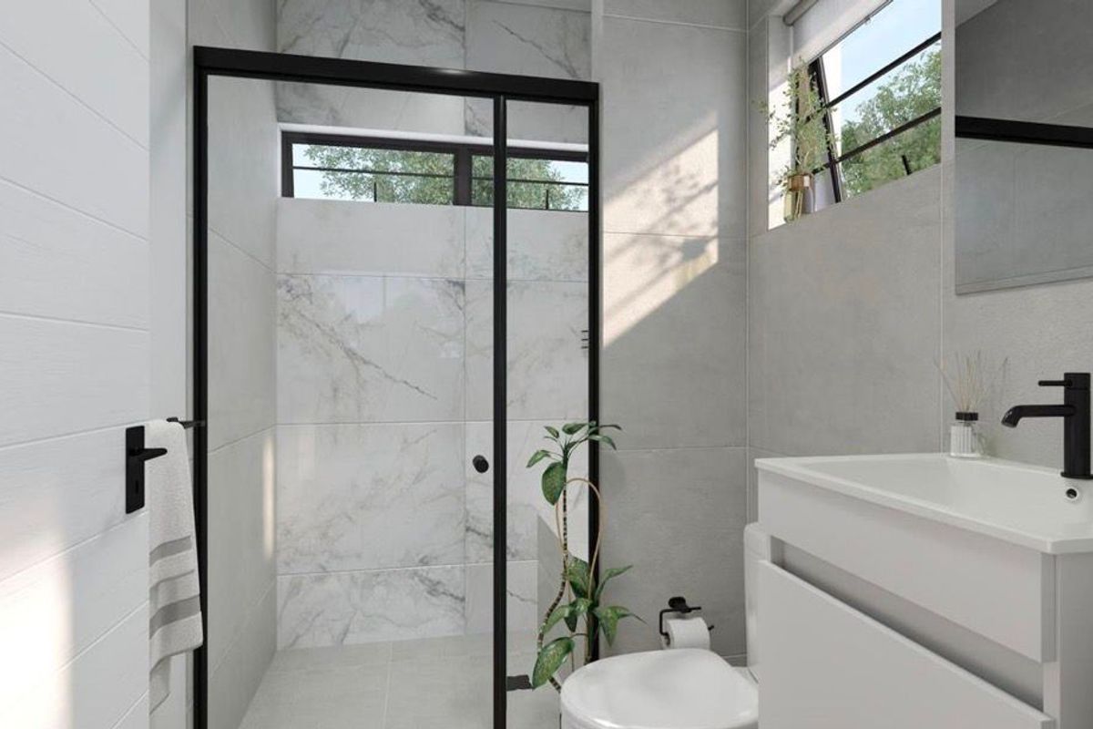 Modern bathroom featuring a walk-in shower with black frame, marble-look wall tiles, and a contemporary vanity unit with matte black fixtures.