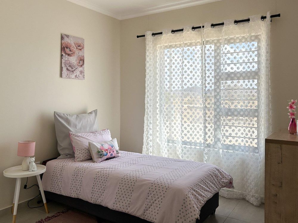 Second bedroom with built-in cupboards.
