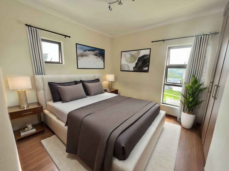 A well-maintained bedroom featuring laminate flooring, built-in wardrobes, and neutral wall finishes, offering a comfortable and functional living space.