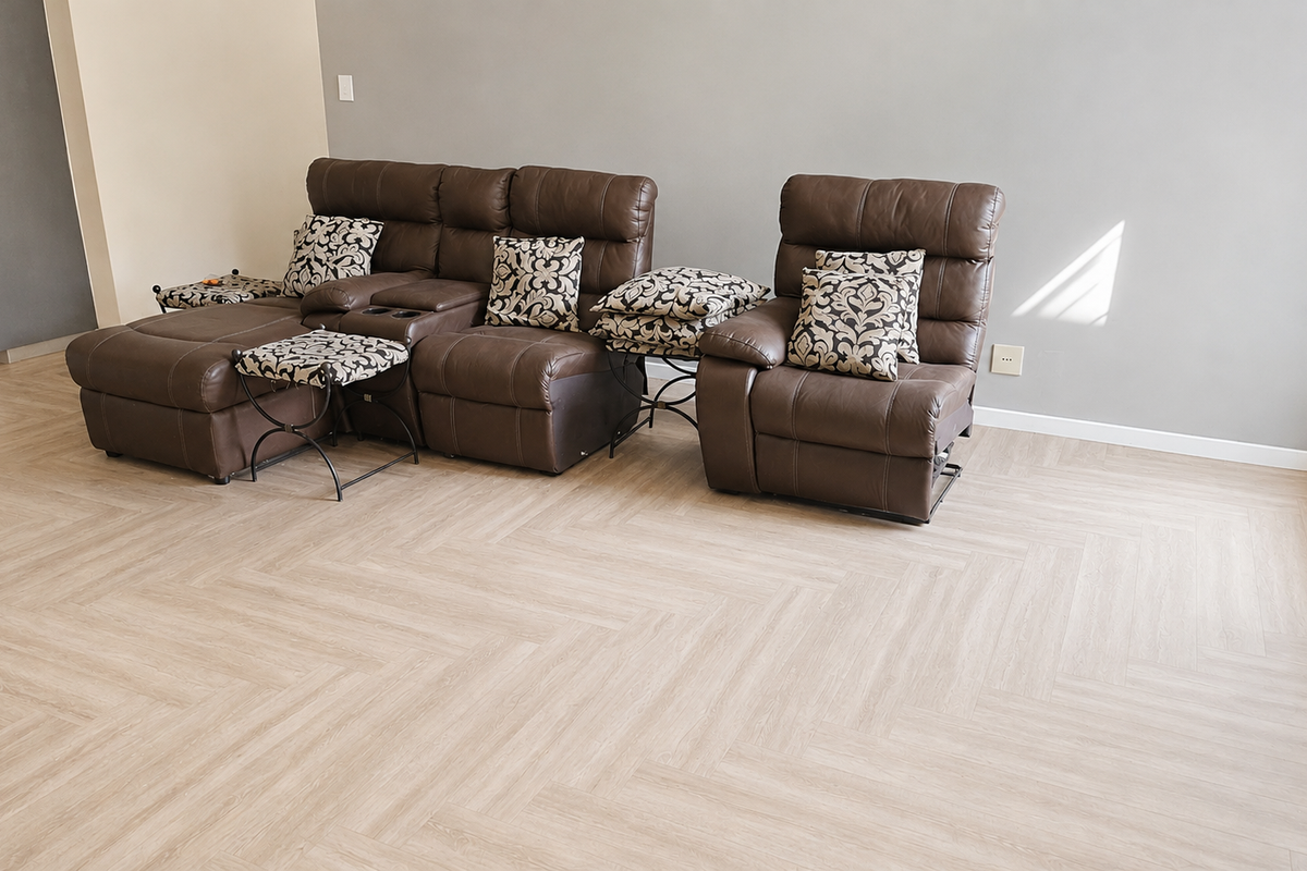 A bright living room featuring modern light-toned herringbone flooring and neutral wall finishes, providing a clean and contemporary foundation for the space.