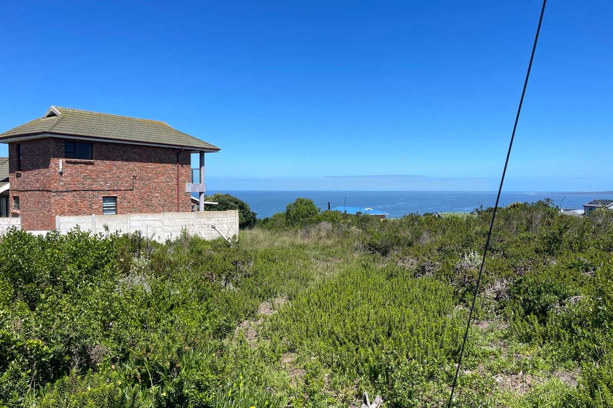 A view of the coastal landscape and ocean from the vacant residential property, featuring natural vegetation and surrounding residential development.