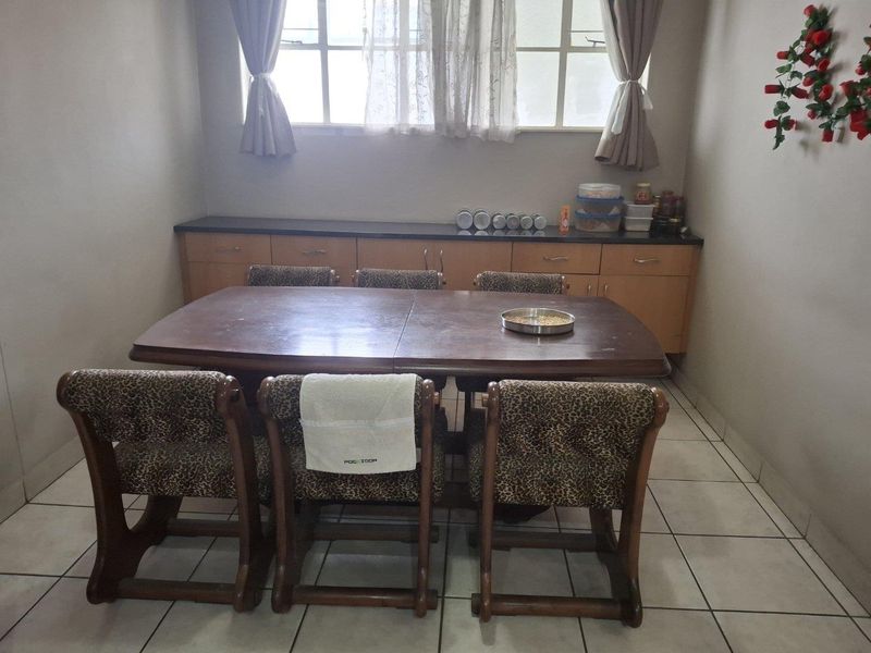 Dining room featuring tiled flooring and built-in cabinetry providing storage space.