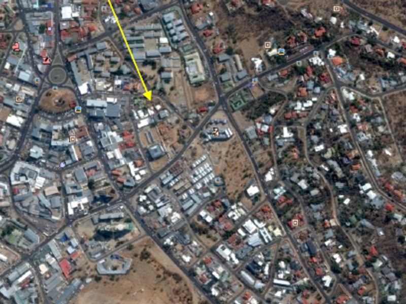 An aerial satellite view of the urban area in Windhoek Central, highlighting the property location with a yellow arrow.