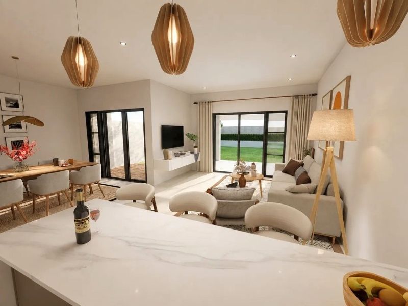Spacious open-plan living and dining area featuring a modern kitchen island, recessed lighting, and large sliding glass doors leading to the garden.