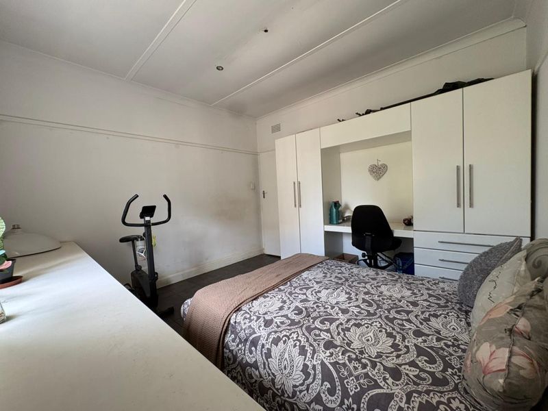 Bedroom featuring built-in cabinetry with an integrated desk, coved ceilings, and recessed lighting.