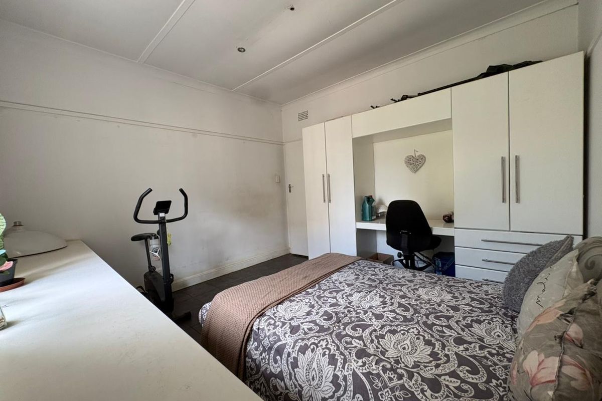 Bedroom featuring built-in cabinetry with an integrated desk, coved ceilings, and recessed lighting.
