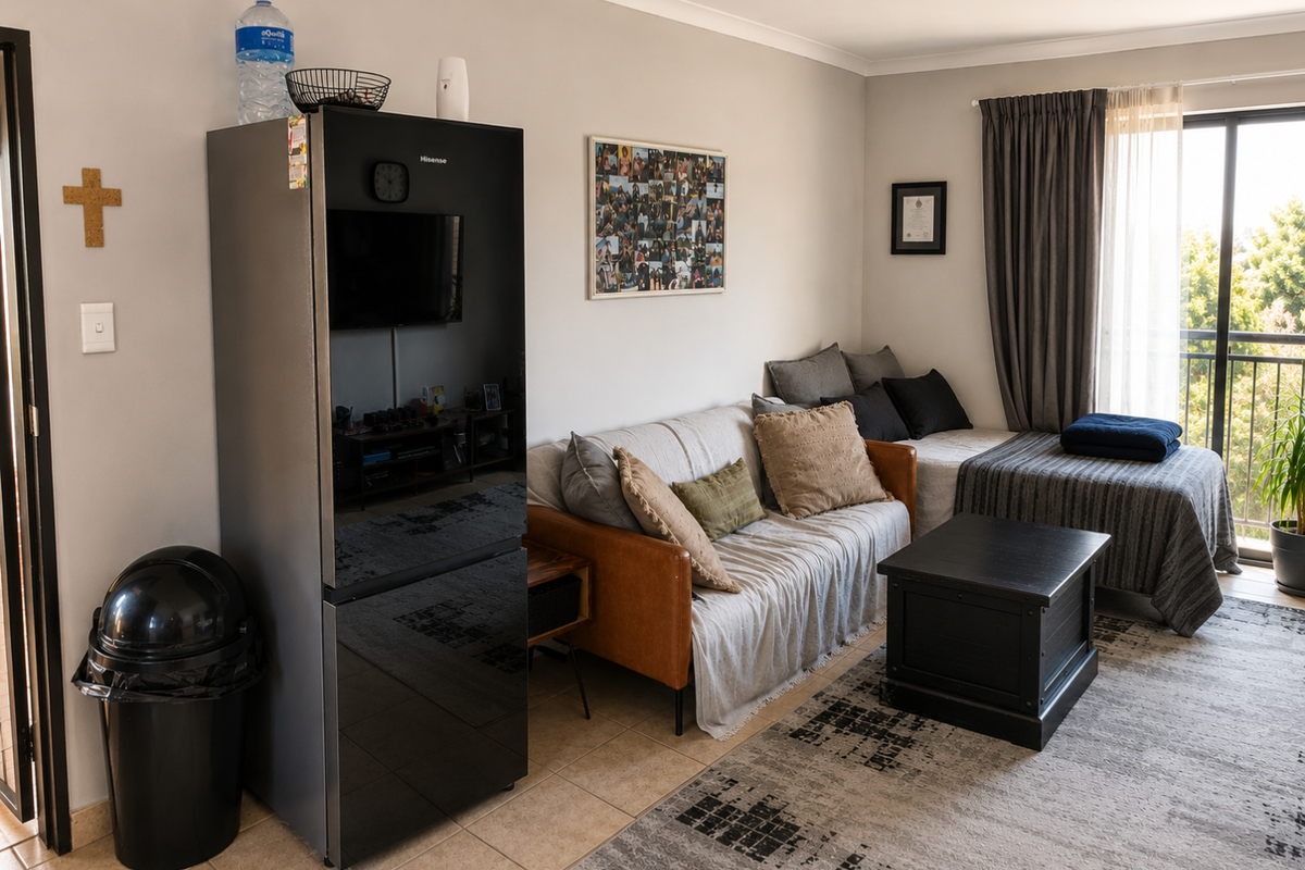A living area featuring tiled flooring and a sliding glass door providing access to an outdoor balcony.