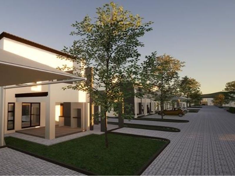 A digital rendering of a modern residential complex featuring paved driveways, landscaped green spaces, and covered parking structures.