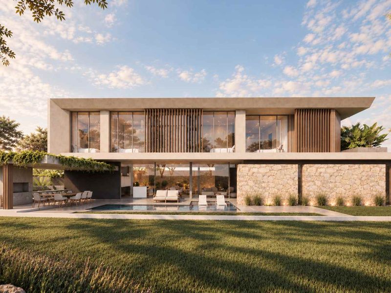 Modern luxury residence featuring a swimming pool, stone-clad facade, timber detailing, and expansive glass doors opening onto a covered patio and landscaped garden.