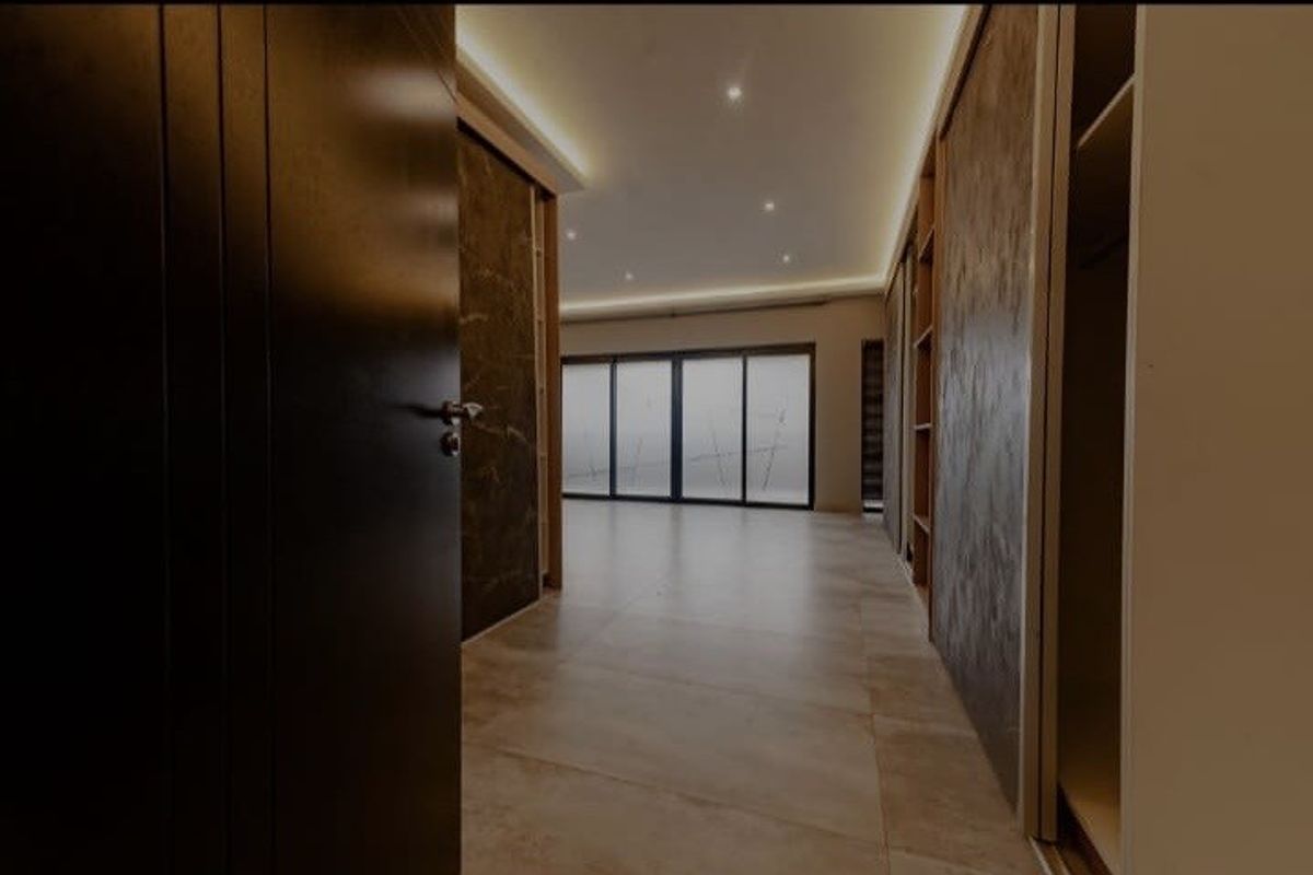 Spacious bedroom featuring modern tiled flooring, built-in wardrobes, recessed ceiling lighting, and large sliding glass doors leading to an outdoor area.