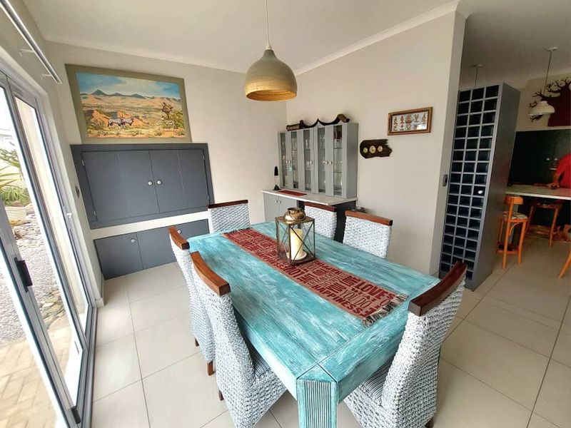 Open plan dining area featuring built-in cabinetry, wine storage, and sliding glass doors leading to the exterior.