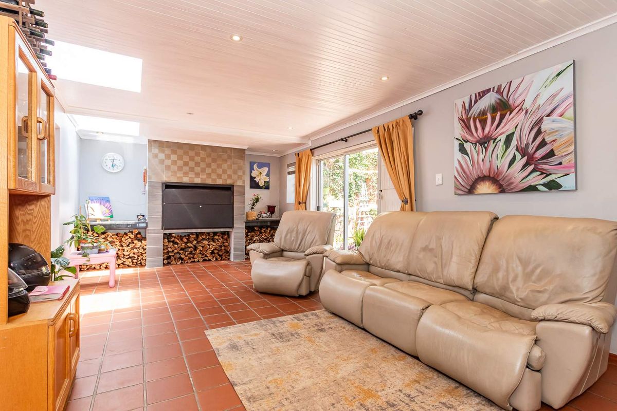 Spacious living room featuring a built-in fireplace, tiled flooring, and sliding glass doors providing natural light and access to the outdoor area.