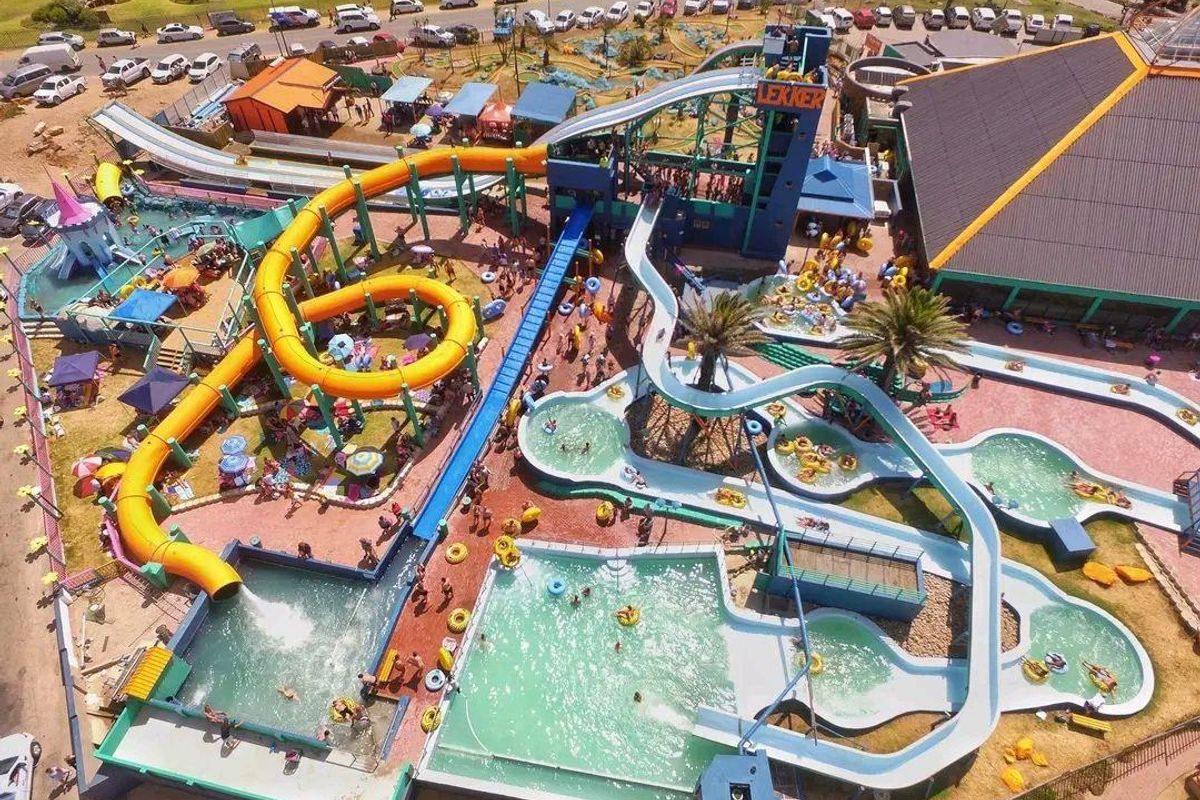 Aerial view of a large outdoor water park facility featuring multiple swimming pools, water slides, and recreational infrastructure.