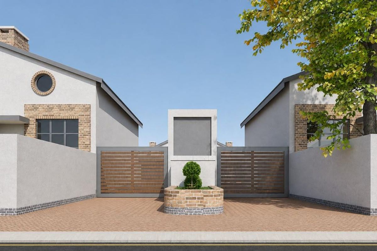 Front elevation of a modern townhouse complex featuring a paved driveway, secure gated entrance, and contemporary architectural brick and plaster finishes.