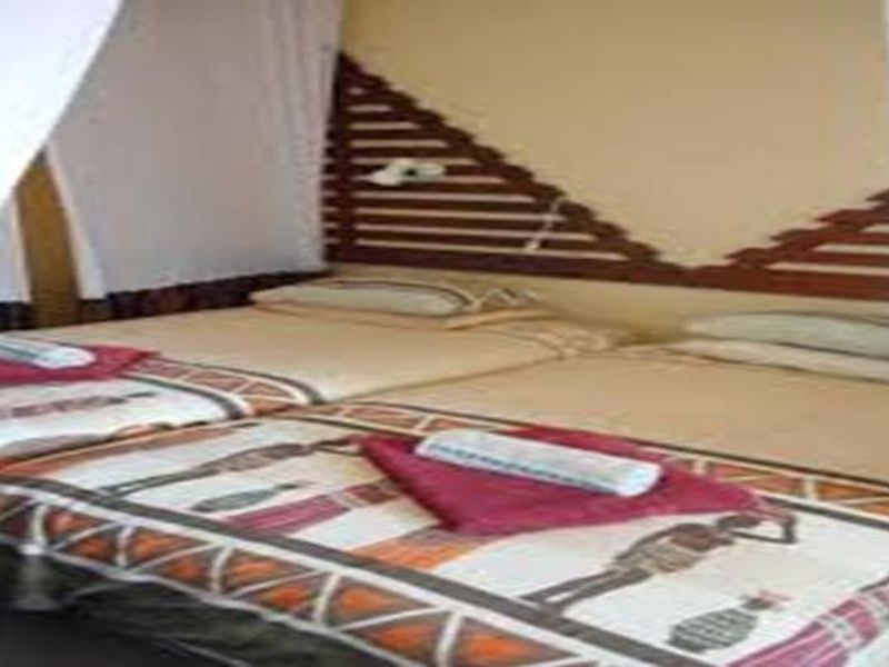 A bedroom featuring a built-in wooden headboard design.