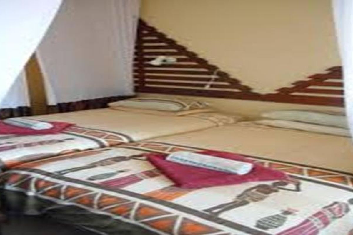A bedroom featuring a built-in wooden headboard design.