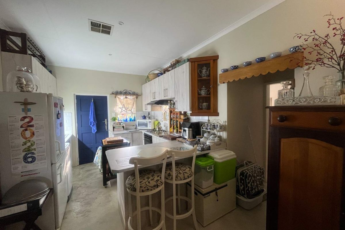 A functional kitchen featuring built-in cabinetry, a breakfast bar, and integrated cooking appliances, offering a practical layout for daily meal preparation.