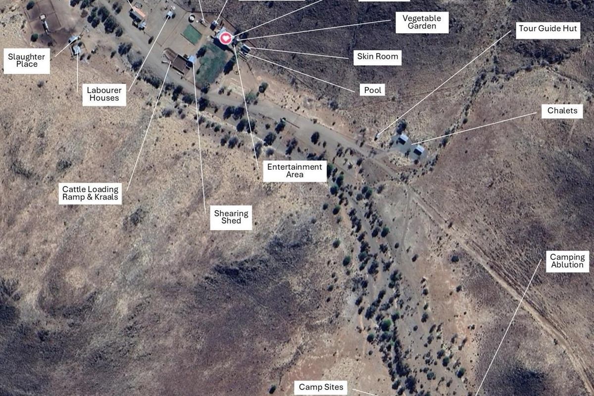 Aerial view of the farm property showing the main farmhouse, various outbuildings, agricultural infrastructure, and designated camping and tourism areas.