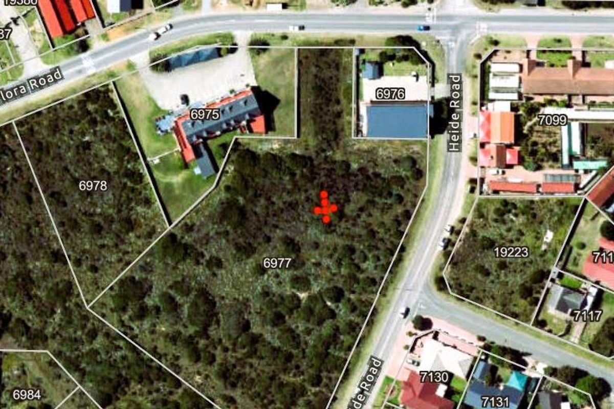 Aerial view of a vacant residential plot located at the corner of Flora Road and Heide Road, featuring natural vegetation and established boundary lines.