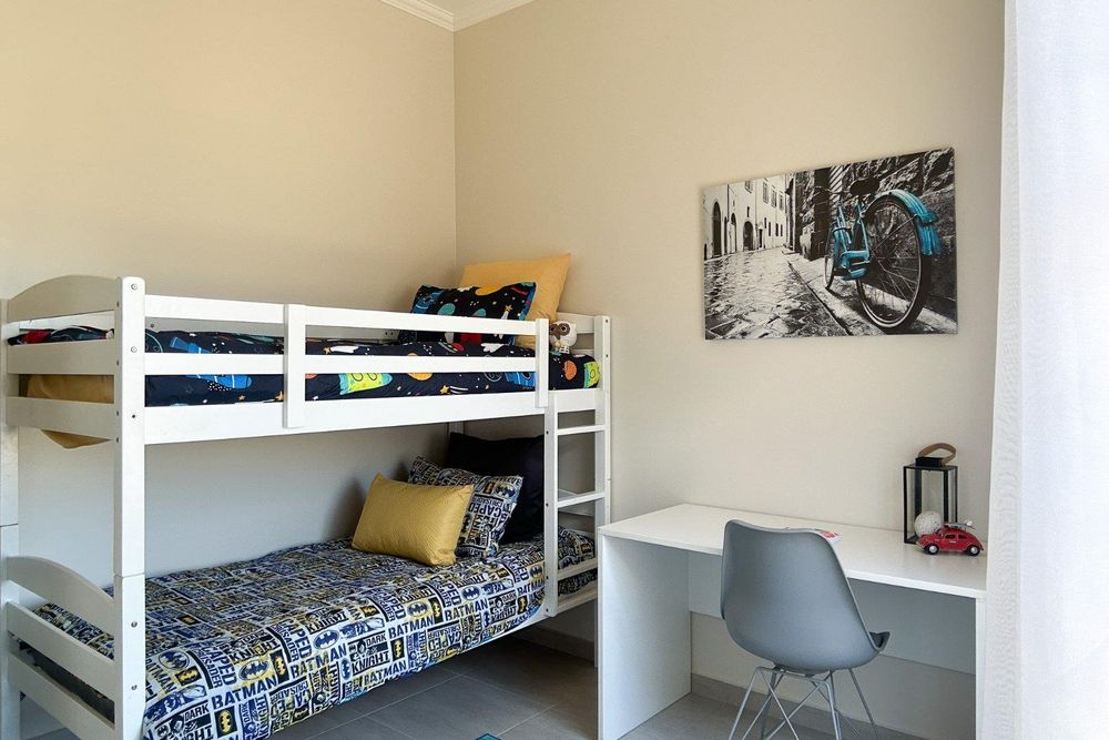 Second bedroom with built-in cupboards.