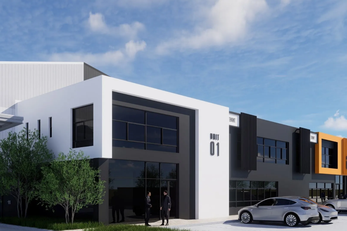 A modern industrial unit facade featuring contemporary architectural design, large glass windows, and clean, high-contrast exterior finishes.