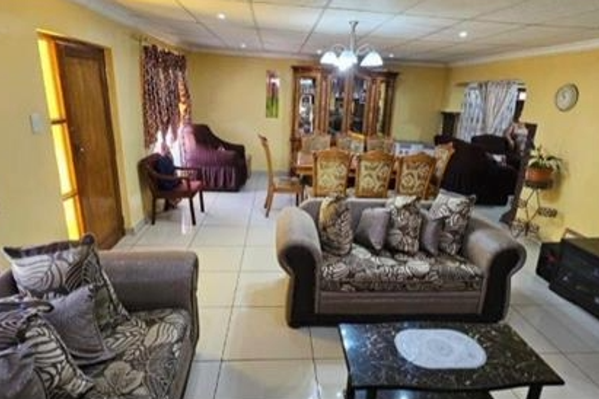 Spacious open-plan living and dining area featuring tiled flooring and recessed ceiling lighting, providing a versatile layout for family living and entertaining.