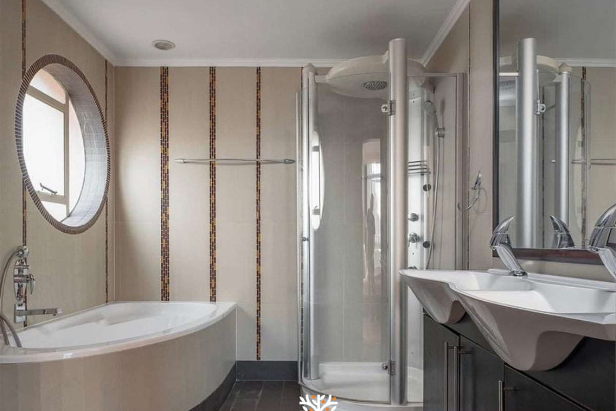 Modern bathroom featuring a curved soaking tub, separate glass-enclosed shower, and a dual-basin vanity with contemporary fixtures.