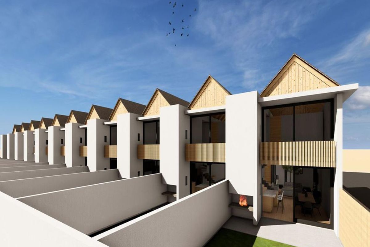 A row of modern townhouses featuring rear patios with built-in braais, timber accents, and large sliding doors opening to private garden spaces.