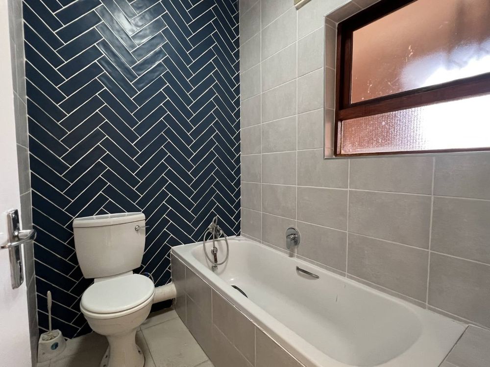 Remodelled bathroom with feature wall