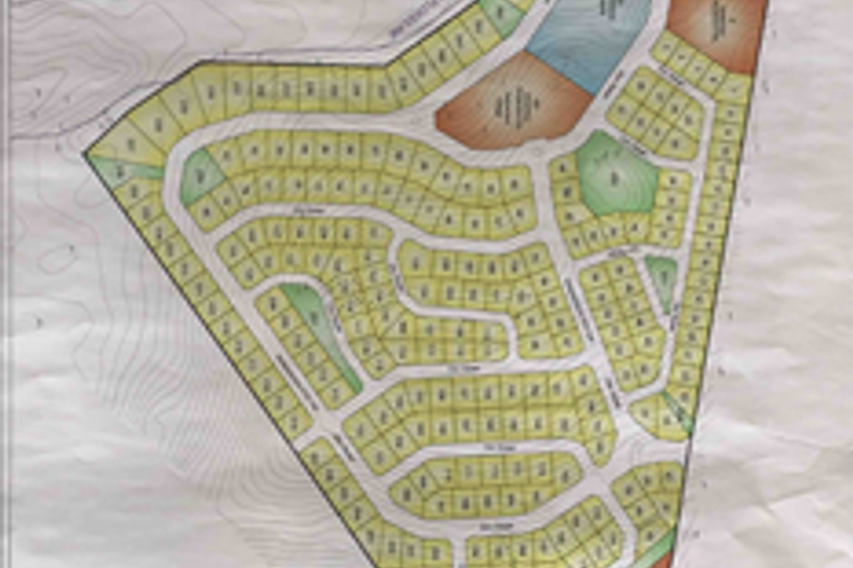 A comprehensive site development plan illustrating the layout of multiple commercial land plots, road networks, and designated zones within the property.