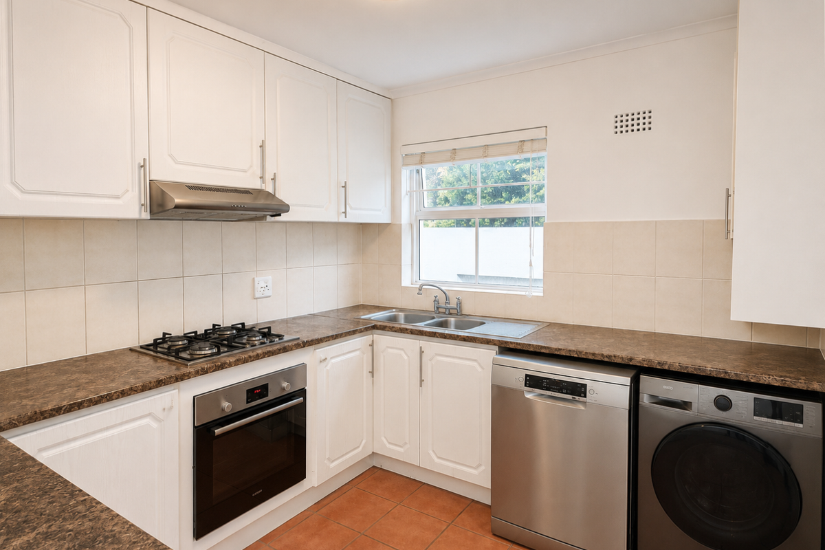 A functional kitchen featuring white cabinetry, laminate countertops, a gas hob, built-in oven, and tiled flooring with space for under-counter appliances.