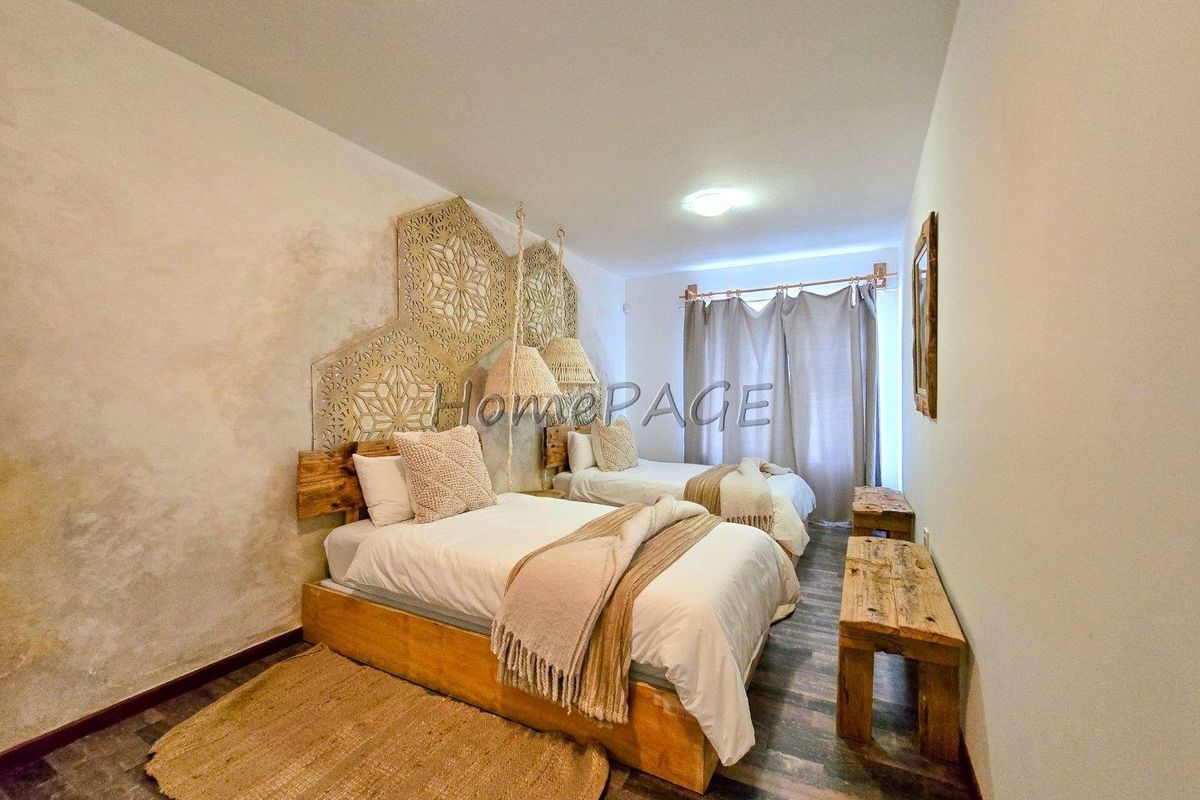 A bedroom featuring laminate flooring and decorative wall panels, providing a cozy and rustic atmosphere.