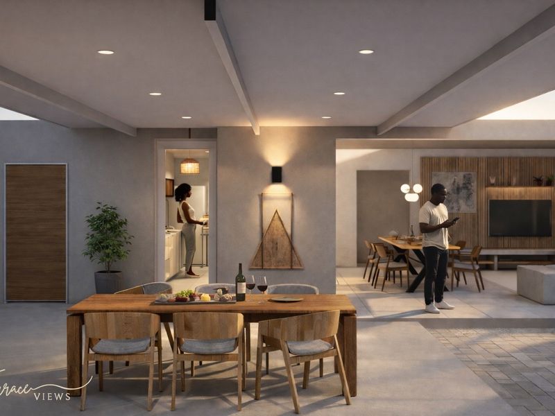 A modern covered patio area featuring recessed lighting, tiled flooring, and seamless transition into the open-plan living and dining spaces.
