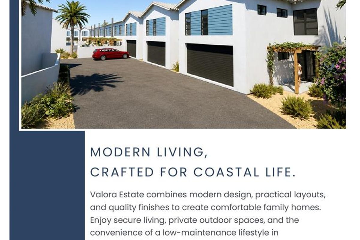 A modern townhouse exterior featuring a paved driveway and double garage doors, showcasing the contemporary architectural design of the Valora Estate development.