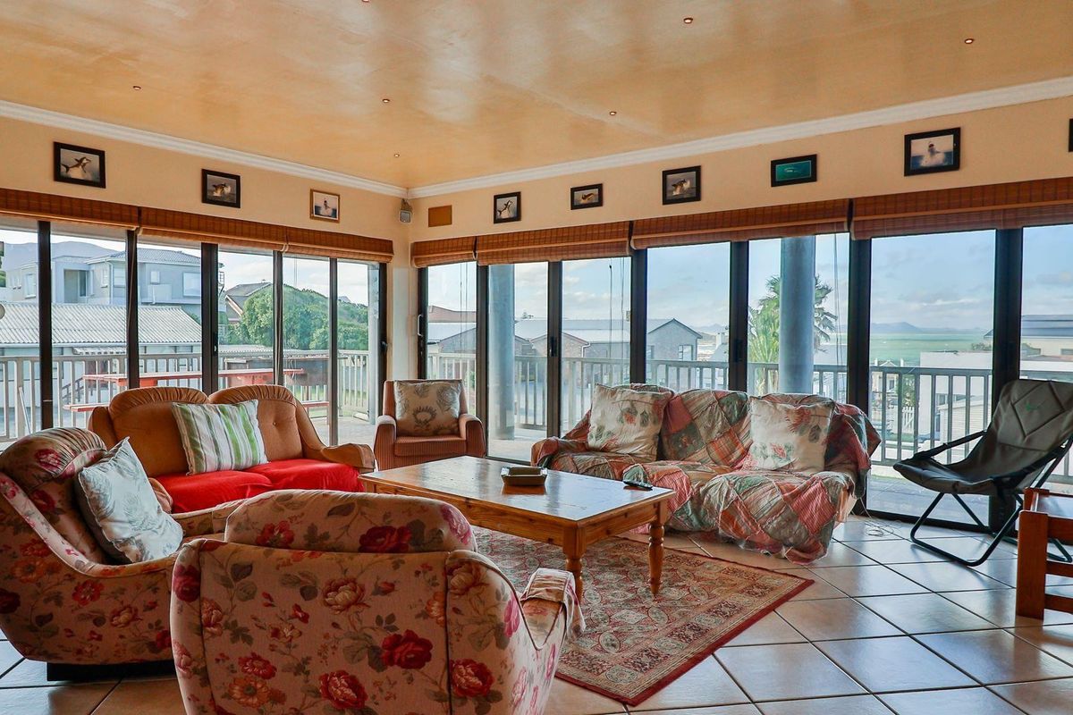 Spacious living area featuring large floor-to-ceiling sliding glass doors that provide abundant natural light and access to an outdoor balcony.