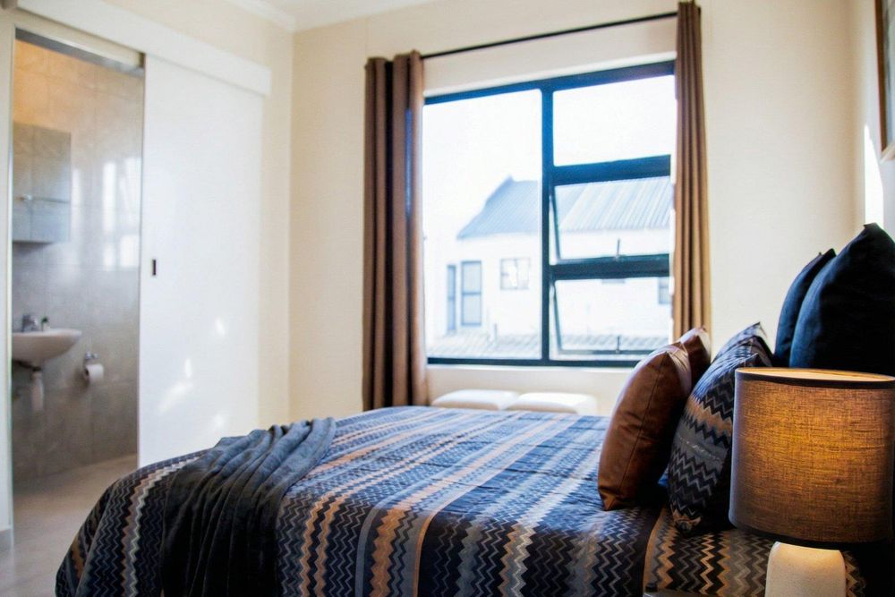 Main bedroom with built-in cupboards and ensuite bathroom.