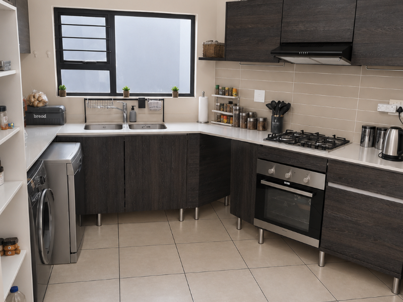 Modern kitchen featuring dark wood grain cabinetry, stone-look countertops, built-in oven, gas hob, extractor fan, and tiled flooring with a double bowl sink.