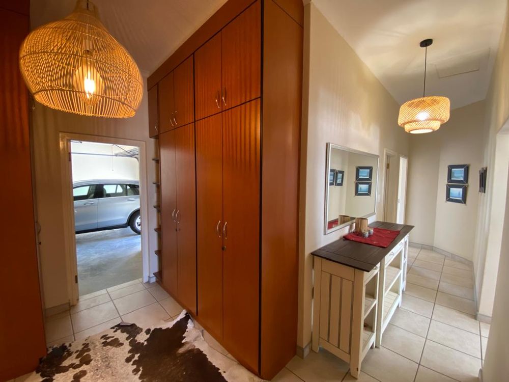 Hallways leading to bedrooms and garage. BIC for extra storage