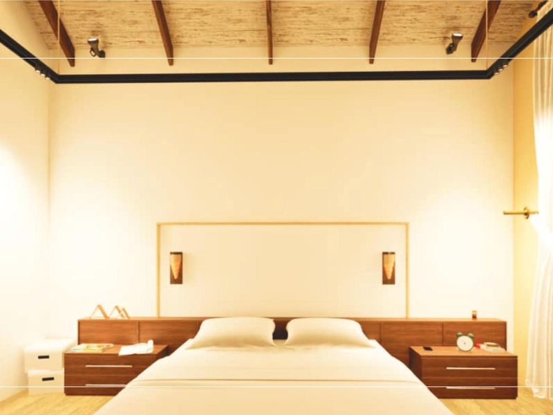 A modern bedroom featuring a high ceiling with exposed timber beams, integrated headboard with built-in bedside cabinetry, and warm ambient lighting.