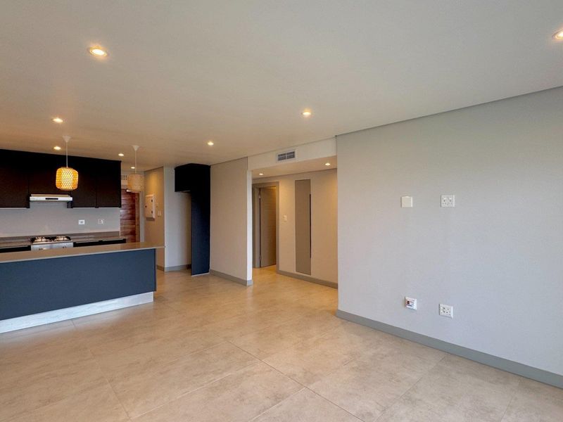 This brand-new, never-before-lived-in apartment offers a refined coastal lifestyle with breathtaking panoramic sea views and sleek, modern finishes throughout - Photo 4