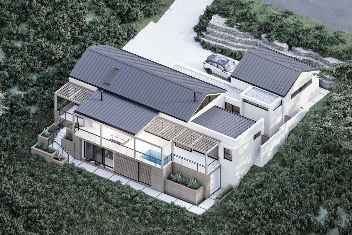 Aerial view of a modern residential property featuring a metal roof, timber pergolas, a swimming pool, and landscaped outdoor areas.