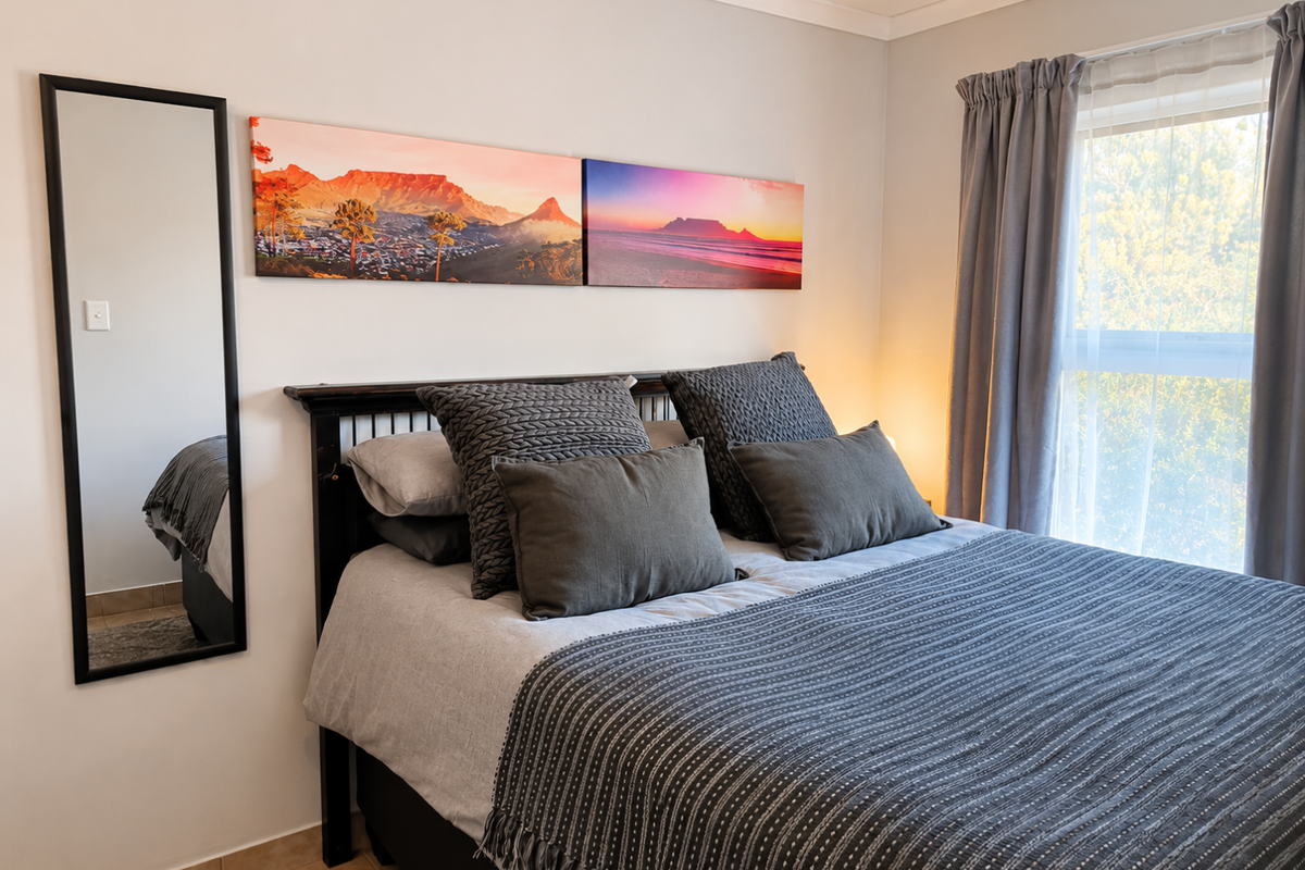 A well-maintained bedroom featuring tiled flooring, neutral wall finishes, and natural light through a window with installed curtain tracks.