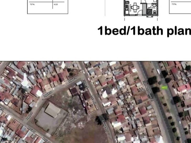 An aerial view of a vacant residential plot situated within a developed urban neighborhood, showing surrounding street layouts and existing properties.