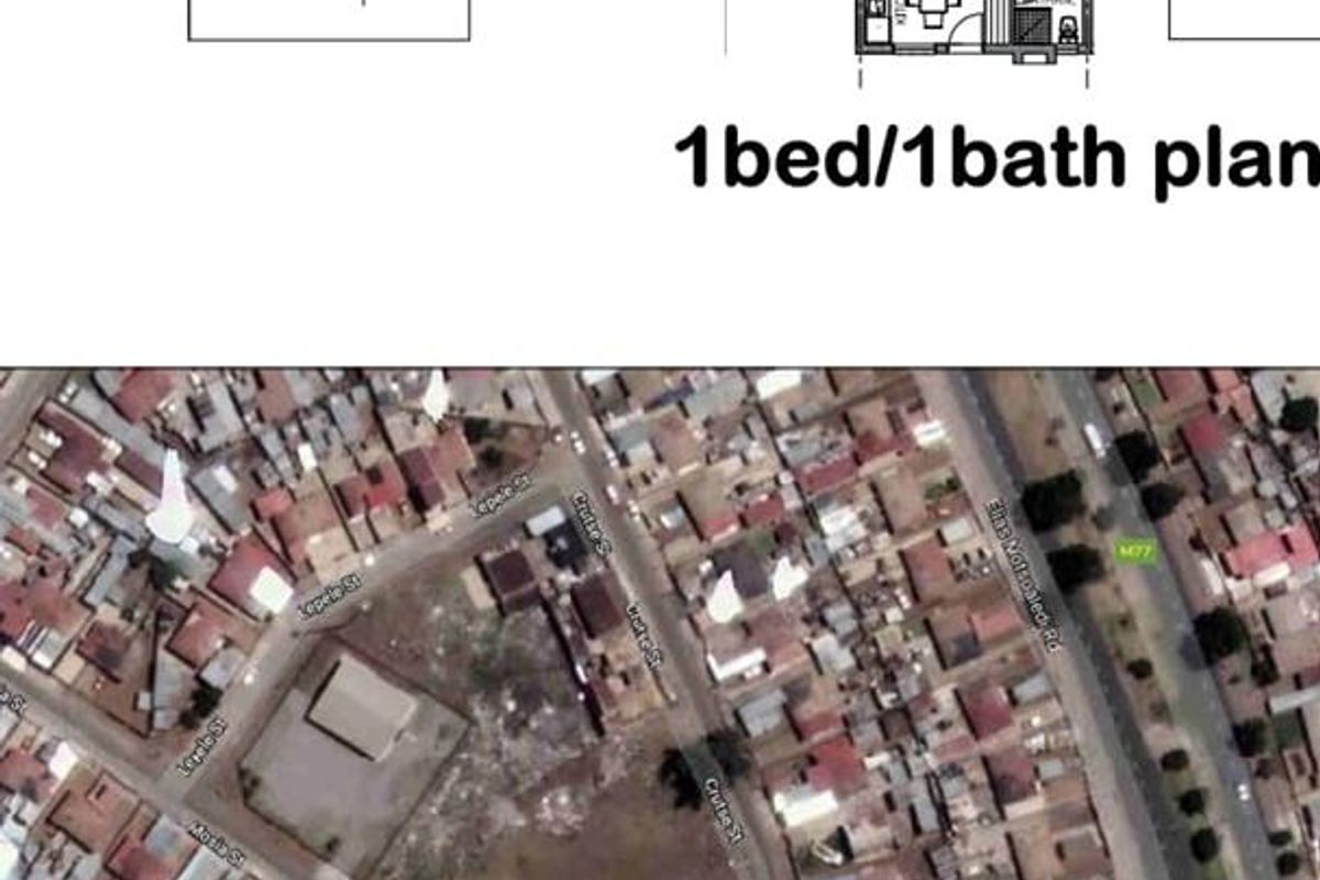 An aerial view of a vacant residential plot situated within a developed urban neighborhood, showing surrounding street layouts and existing properties.