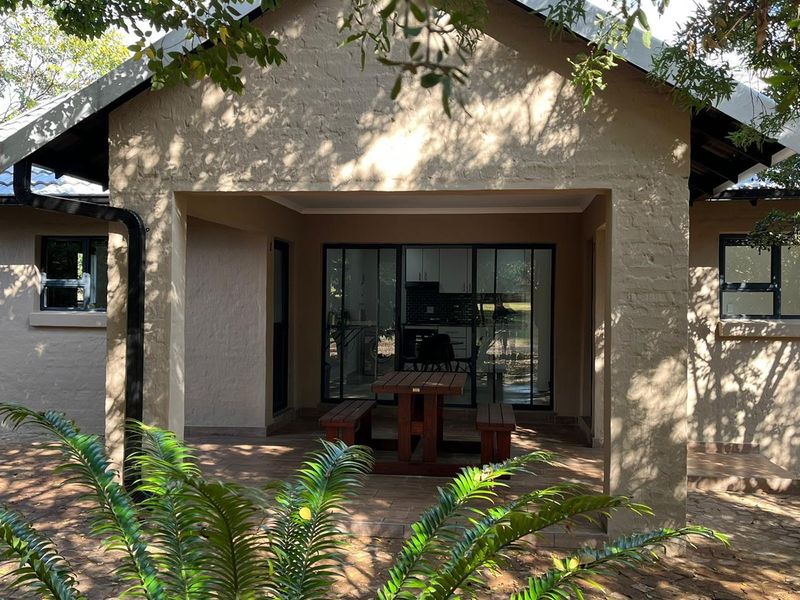 A covered patio area featuring tiled flooring and sliding glass doors, providing a seamless transition to the interior living space.