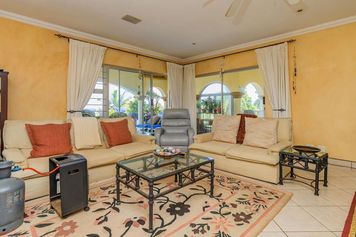 A spacious living room featuring large sliding glass doors that provide natural light and access to the outdoor patio area.