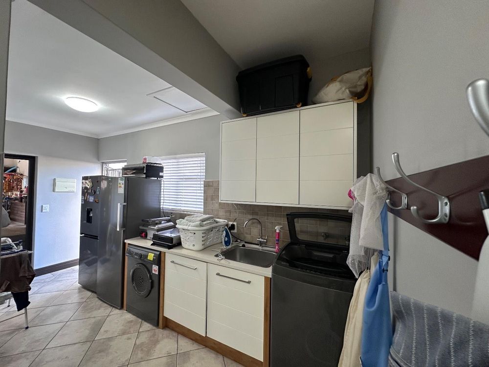 Scullery behind kitchen linking to the gargag and courtyard